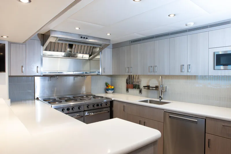 No Bad Ideas Yacht Photos Pics Modern kitchen interior on 2000 Trinity Yachts Trinity 160, featuring stainless steel appliances.