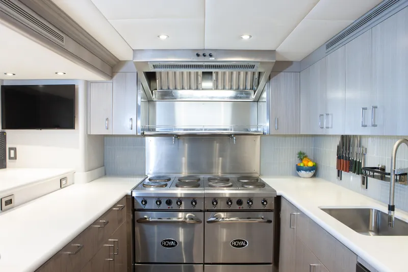No Bad Ideas Yacht Photos Pics Modern kitchen in 2000 Trinity Yachts Trinity 160, featuring stainless steel appliances and sleek cabinetry.