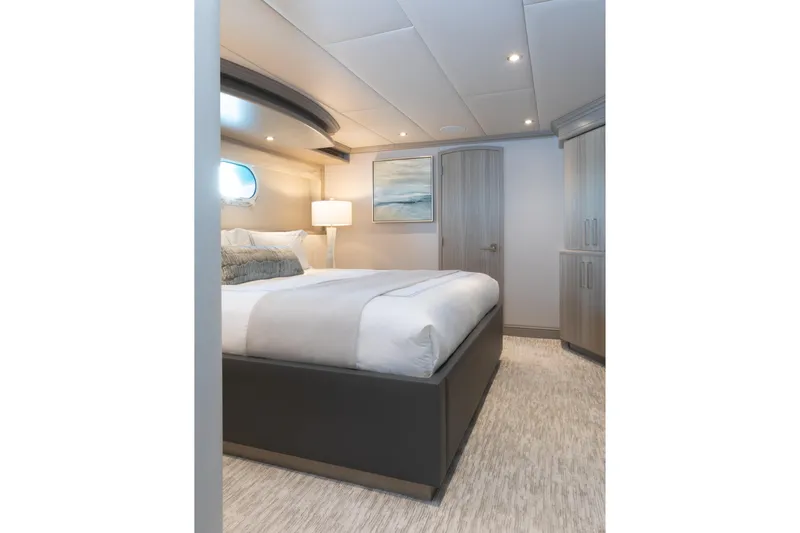 No Bad Ideas Yacht Photos Pics Luxurious bedroom interior on 2000 Trinity Yachts Trinity 160, featuring modern decor and ambient lighting.