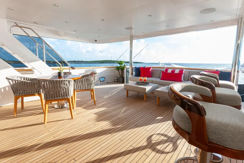 No Bad Ideas Yacht Photos Pics Luxurious deck of 2000 Trinity Yachts Trinity 160, featuring elegant seating and ocean view.