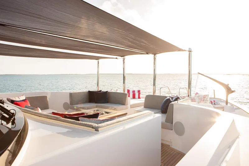 No Bad Ideas Yacht Photos Pics Luxurious Trinity Yachts Trinity 160 deck with elegant seating, ocean view, and sunshade.