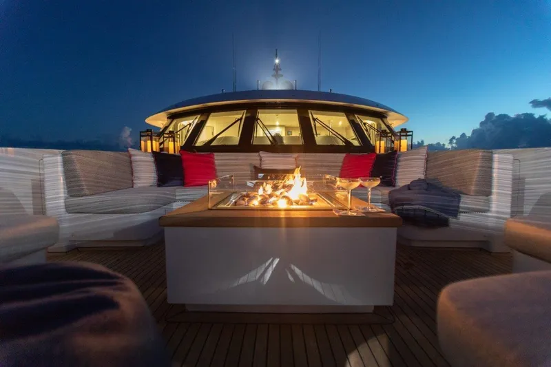 No Bad Ideas Yacht Photos Pics Luxurious Trinity 160 yacht deck with fire pit and seating at sunset, 2000 model.