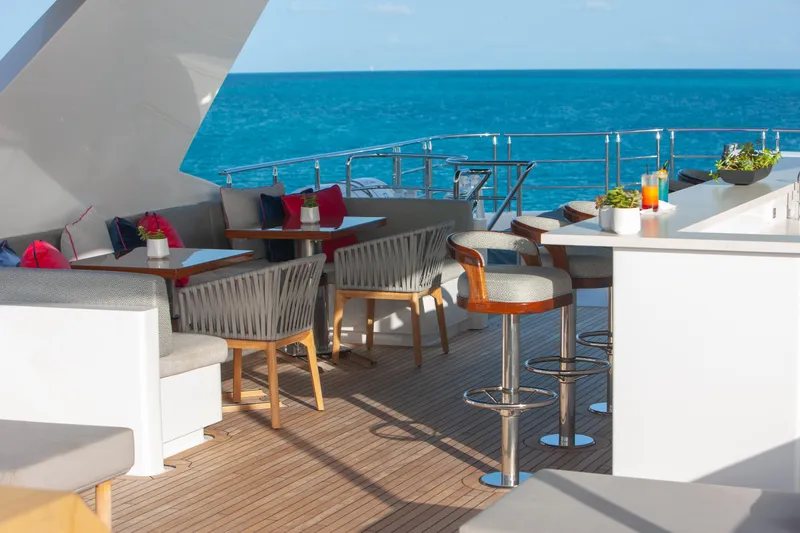 No Bad Ideas Yacht Photos Pics Luxurious deck of 2000 Trinity Yachts Trinity 160 with ocean view and elegant seating.