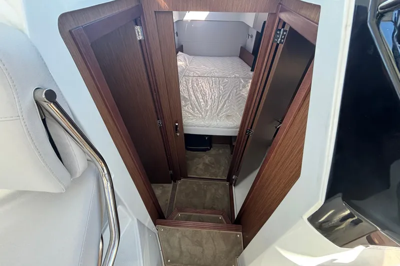  Yacht Photos Pics Interior cabin view of 2026 Beneteau Antares 9 V2, featuring wood finish and cozy bedding.