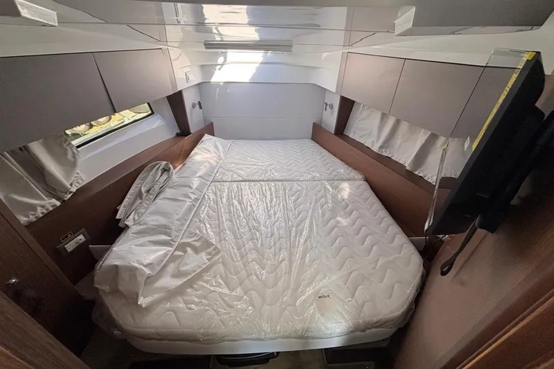  Yacht Photos Pics Luxurious cabin interior of 2026 Beneteau Antares 9 V2 with cozy bed and modern design.