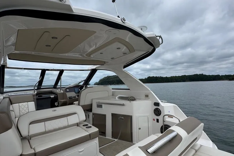  Yacht Photos Pics 2018 Regal 35 Sport Coupe interior with luxurious seating on a calm lake.