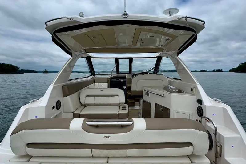  Yacht Photos Pics 2018 Regal 35 Sport Coupe interior with luxurious seating on a serene lake.