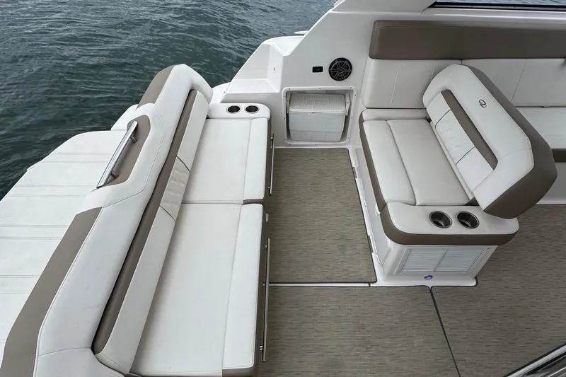  Yacht Photos Pics 2018 Regal 35 Sport Coupe boat interior with beige seating and cup holders.