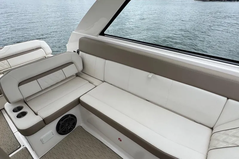  Yacht Photos Pics Luxurious seating on 2018 Regal 35 Sport Coupe boat, overlooking serene water.