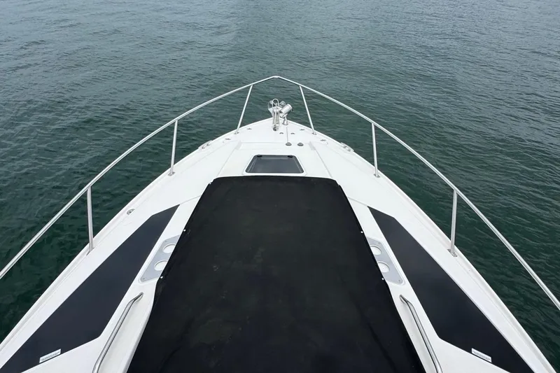 Yacht Photos Pics Bow view of 2018 Regal 35 Sport Coupe on calm water.