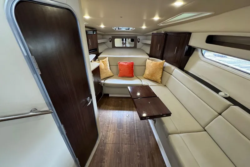  Yacht Photos Pics Interior of 2018 Regal 35 Sport Coupe with beige seating and colorful cushions.