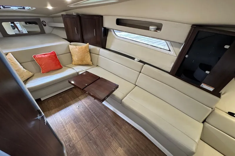  Yacht Photos Pics Luxurious interior of 2018 Regal 35 Sport Coupe with beige seating and wooden accents.