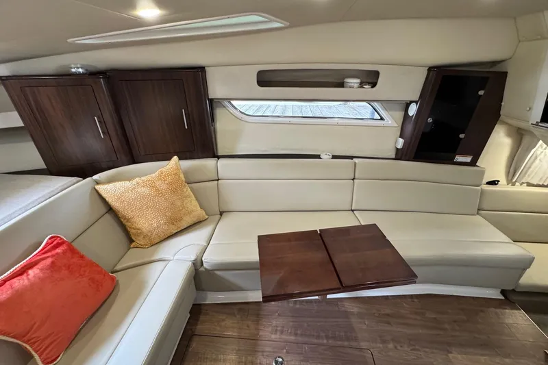  Yacht Photos Pics Interior of 2018 Regal 35 Sport Coupe with beige seating and wooden accents.