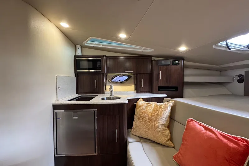  Yacht Photos Pics 2018 Regal 35 Sport Coupe interior with kitchenette, microwave, and cozy seating area.