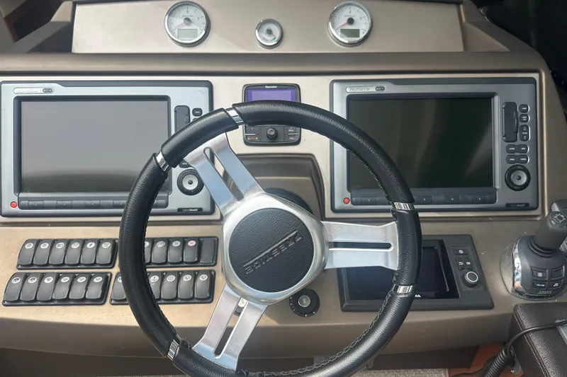  Yacht Photos Pics Steering wheel and dashboard of 2013 Prestige 500 S yacht with navigation screens.