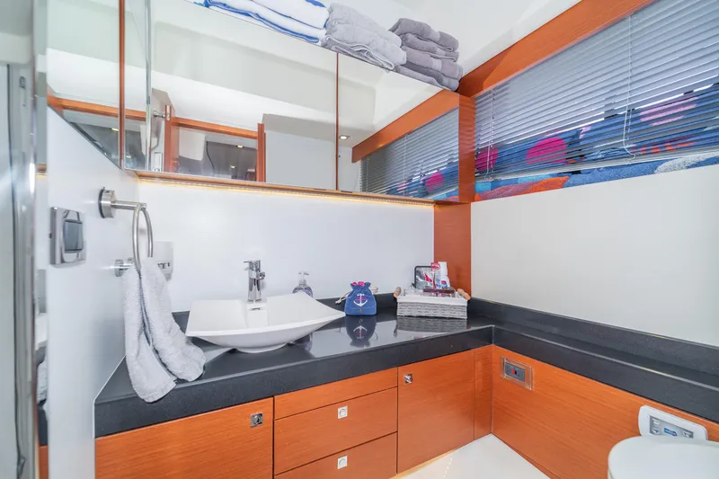  Yacht Photos Pics Luxurious bathroom in 2013 Prestige 500 S yacht with modern fixtures and wooden cabinetry.