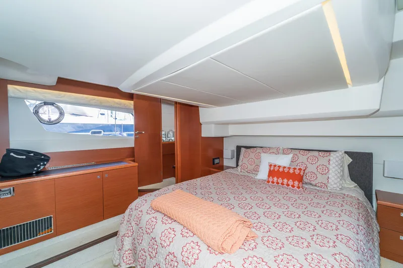  Yacht Photos Pics Luxurious bedroom interior of 2013 Prestige 500 S yacht with patterned bedding and wooden cabinetry.