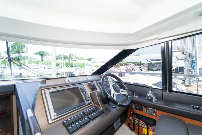  Yacht Photos Pics Interior view of 2013 Prestige 500 S yacht cockpit with steering wheel and navigation system.