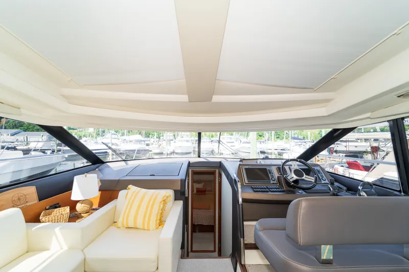  Yacht Photos Pics Luxurious interior of 2013 Prestige 500 S yacht with modern helm and seating area.