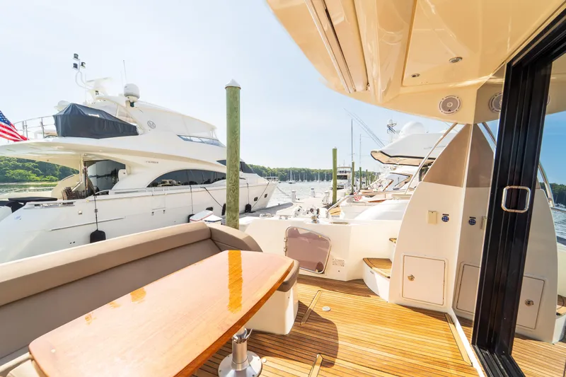  Yacht Photos Pics Luxurious 2013 Prestige 500 S yacht docked, featuring elegant outdoor seating and polished wood deck.