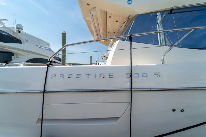  Yacht Photos Pics 2013 Prestige 500 S yacht docked, showcasing sleek design and branding.