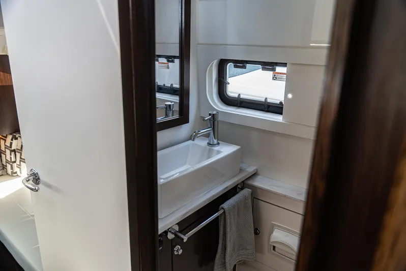  Yacht Photos Pics Modern bathroom interior in 2021 Pursuit 428, featuring sleek sink and window.