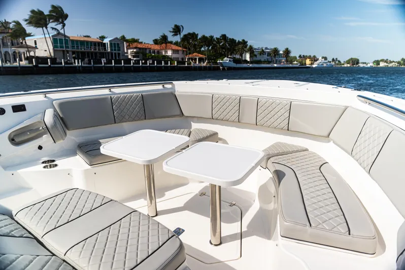  Yacht Photos Pics Luxurious seating area on a 2021 Pursuit 428 boat with waterfront view.
