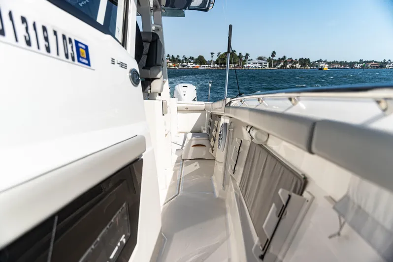  Yacht Photos Pics 2021 Pursuit 428 boat deck with ocean view, showcasing sleek design and spacious layout.