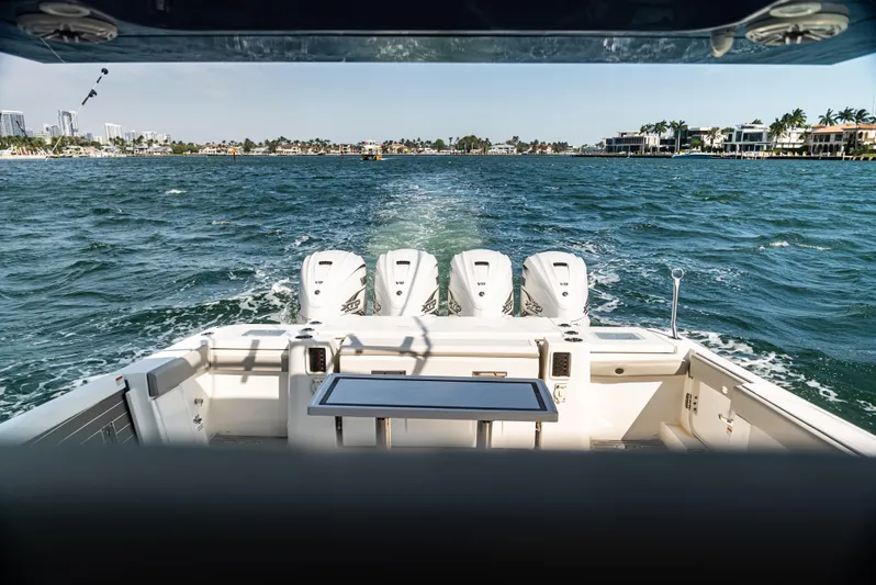  Yacht Photos Pics 2021 Pursuit 428 boat cruising on open water with powerful engines.