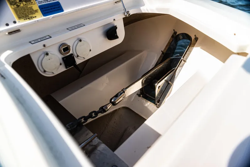  Yacht Photos Pics Anchor compartment of 2021 Pursuit 428 boat with chain and controls.