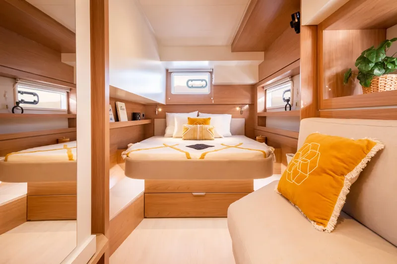 Roxy Yacht Photos Pics Luxurious 2022 Bali 4.4 yacht cabin with cozy bed, elegant decor, and natural light.