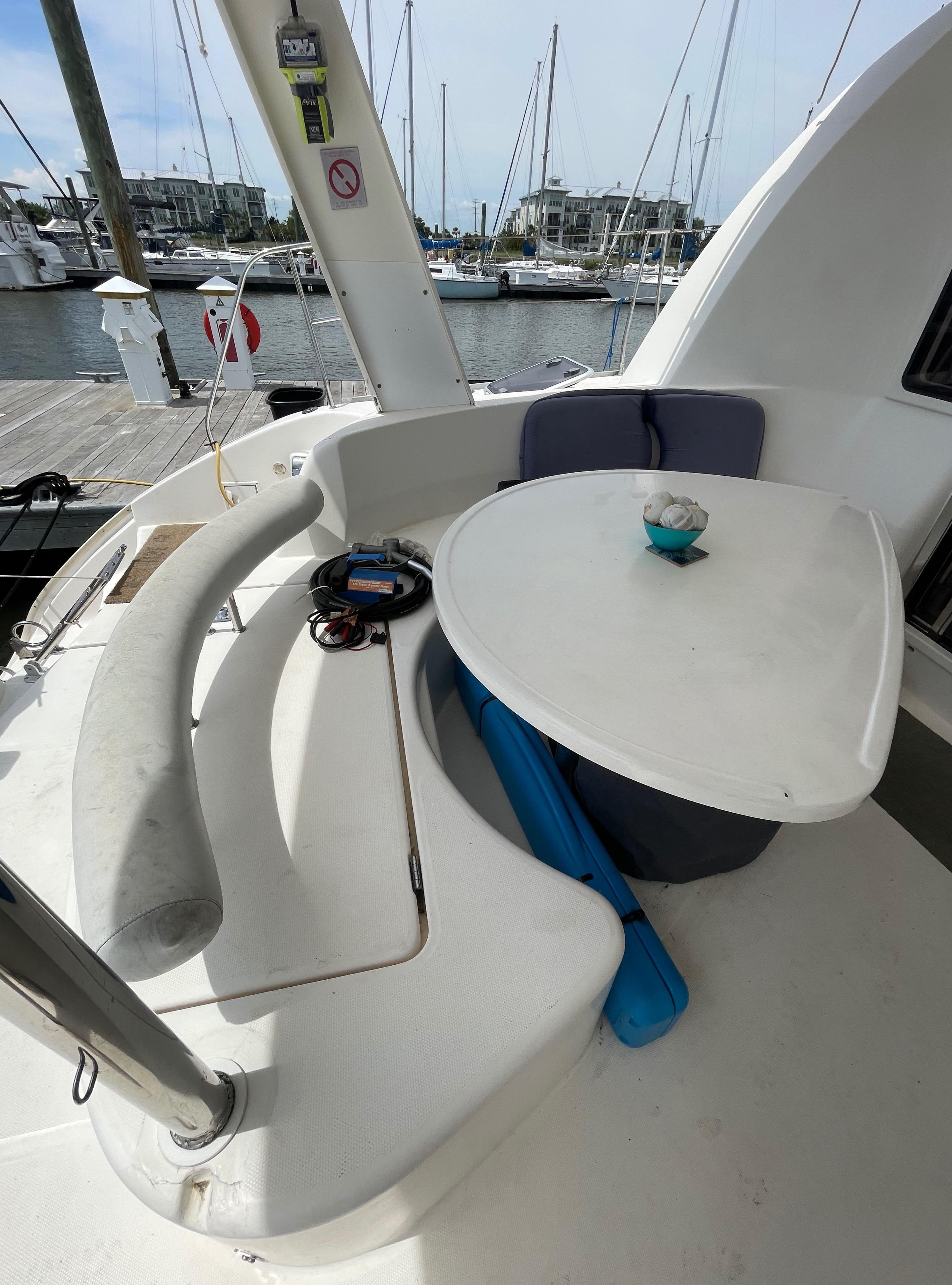 Leopard 40 catamaran cockpit with seating and table, docked at marina, 2005 model.