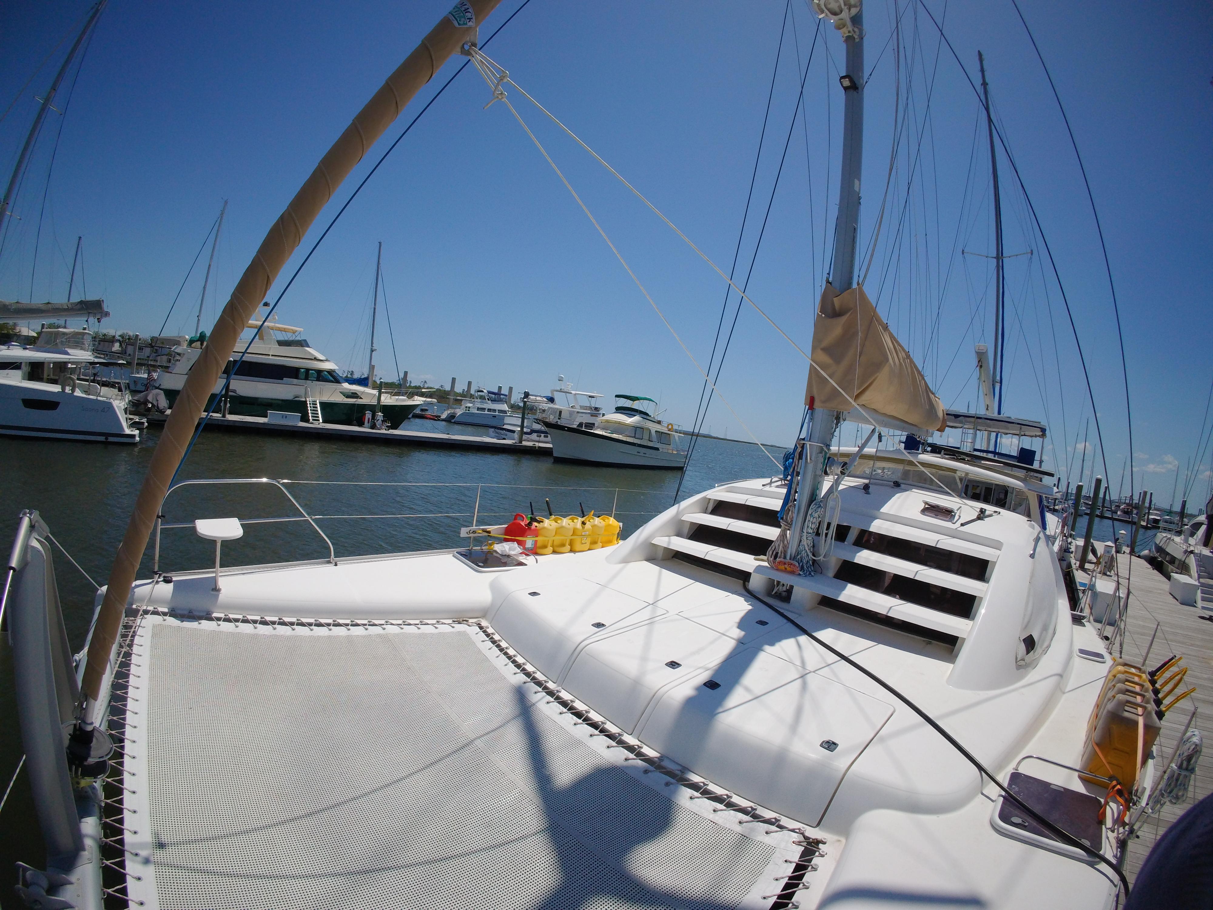 Catamaran Leopard 40, 2005 model, docked at marina with clear blue sky.