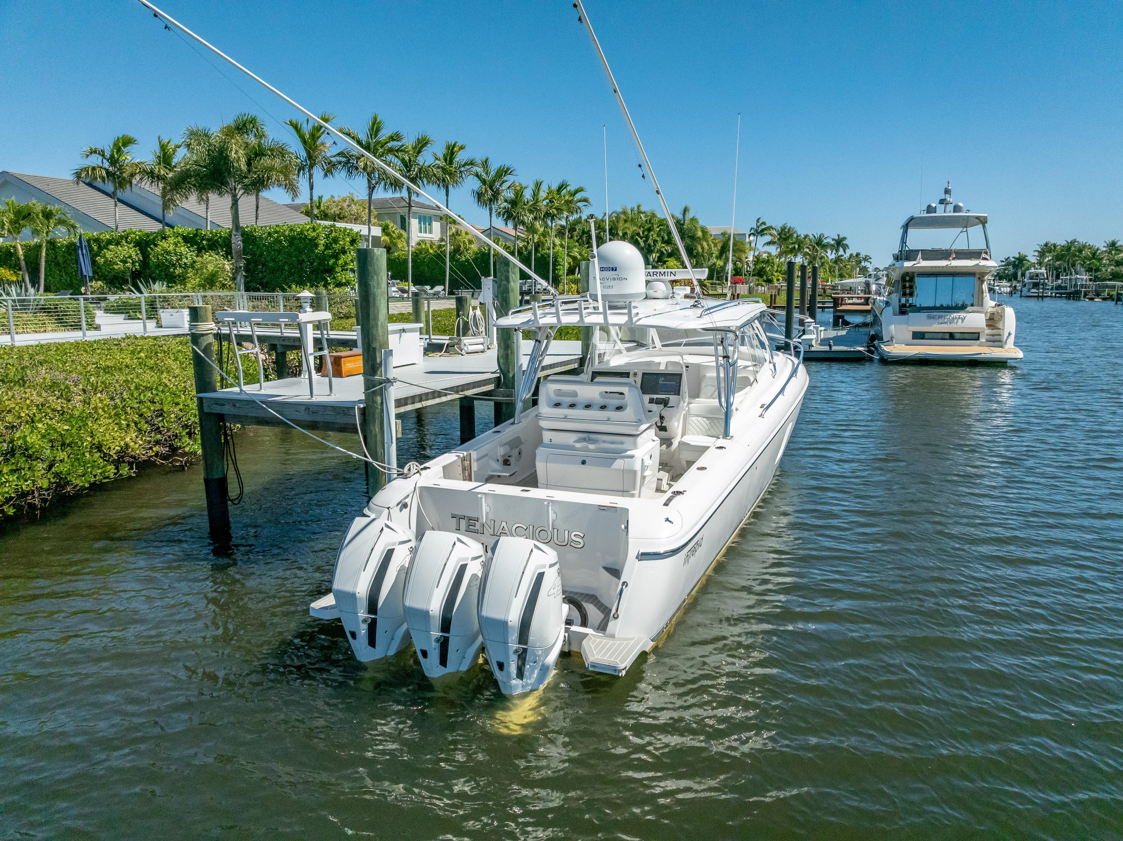  Yacht Photos Pics 2020 Intrepid 407 Cuddy boat docked in marina, featuring triple outboard engines.
