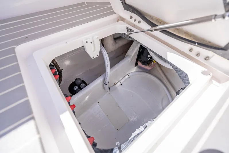  Yacht Photos Pics Open storage compartment in 2020 Intrepid 407 Cuddy boat, showcasing interior details.