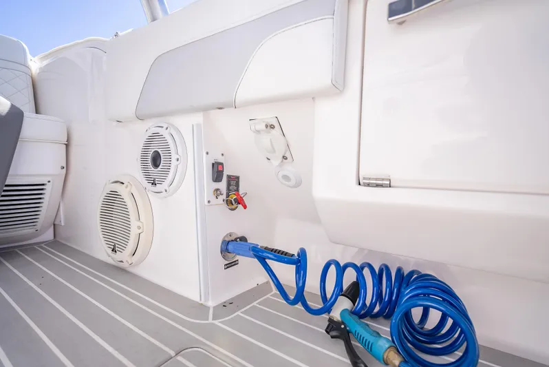  Yacht Photos Pics 2020 Intrepid 407 Cuddy boat interior with speaker and coiled blue hose.