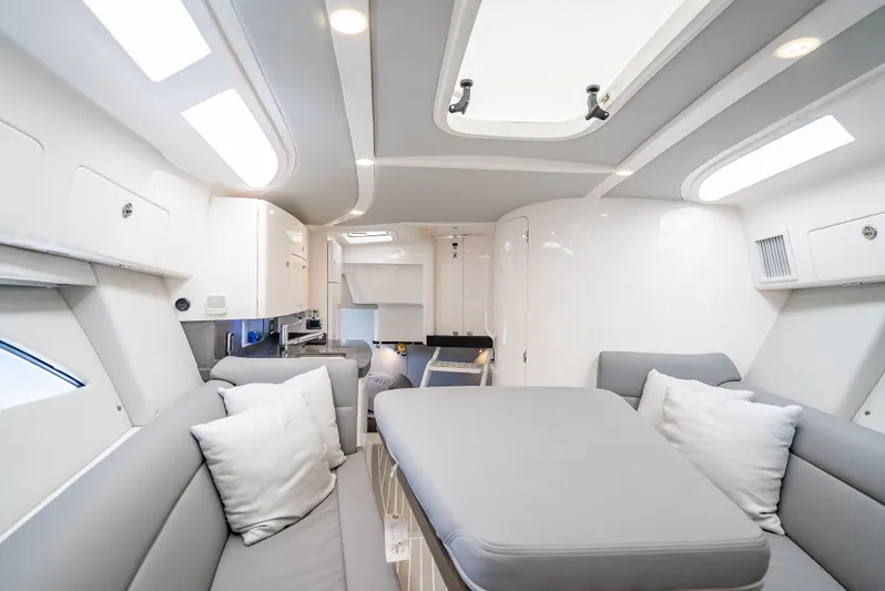  Yacht Photos Pics Luxurious interior of a 2020 Intrepid 407 Cuddy boat with modern seating and skylight.