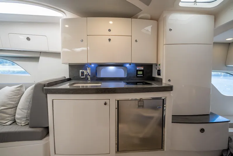  Yacht Photos Pics 2020 Intrepid 407 Cuddy interior kitchen with modern cabinetry and compact design.