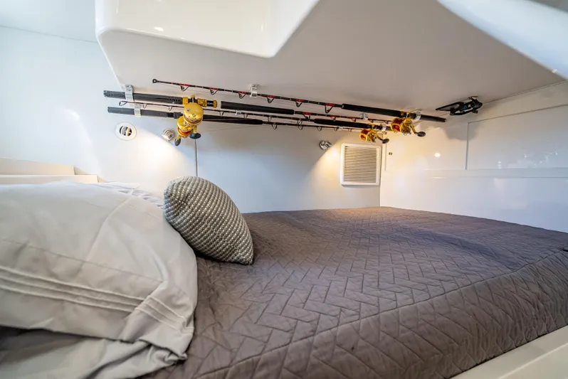  Yacht Photos Pics Intrepid 407 Cuddy 2020 interior cabin with bed and fishing rod storage.