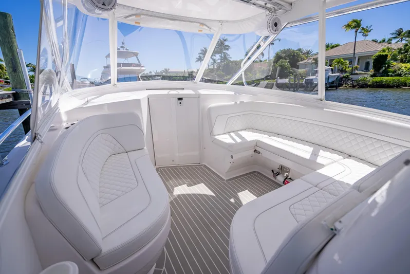  Yacht Photos Pics Luxurious interior of 2020 Intrepid 407 Cuddy boat with white seating and clear views.