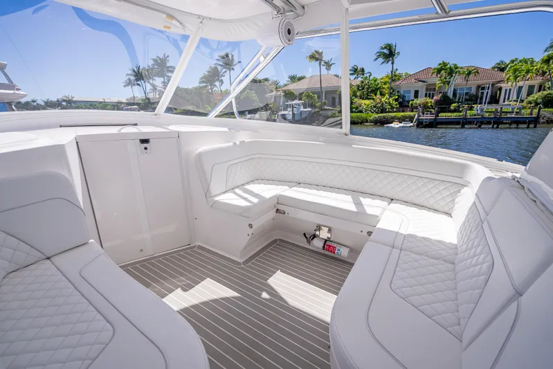  Yacht Photos Pics Luxurious interior of 2020 Intrepid 407 Cuddy boat with white seating and waterfront view.