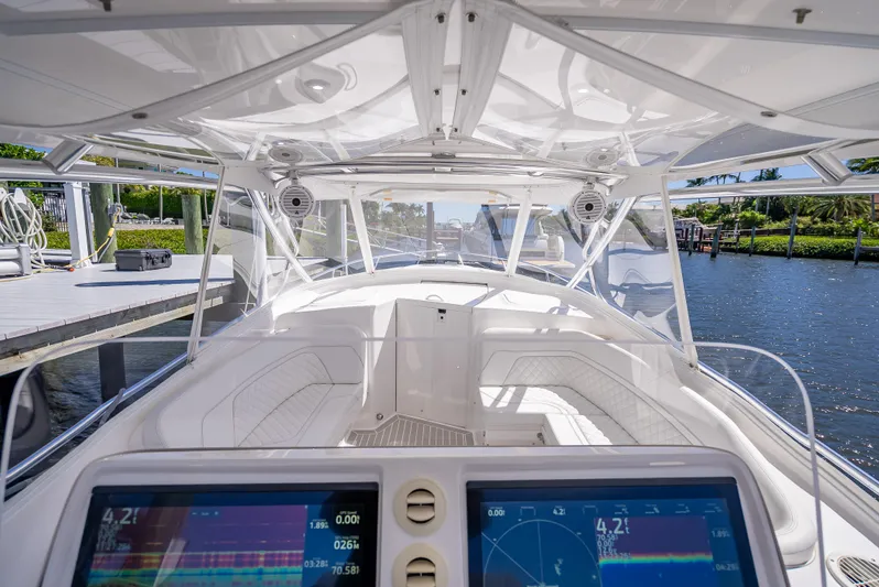  Yacht Photos Pics 2020 Intrepid 407 Cuddy boat interior with advanced navigation displays, docked by the water.