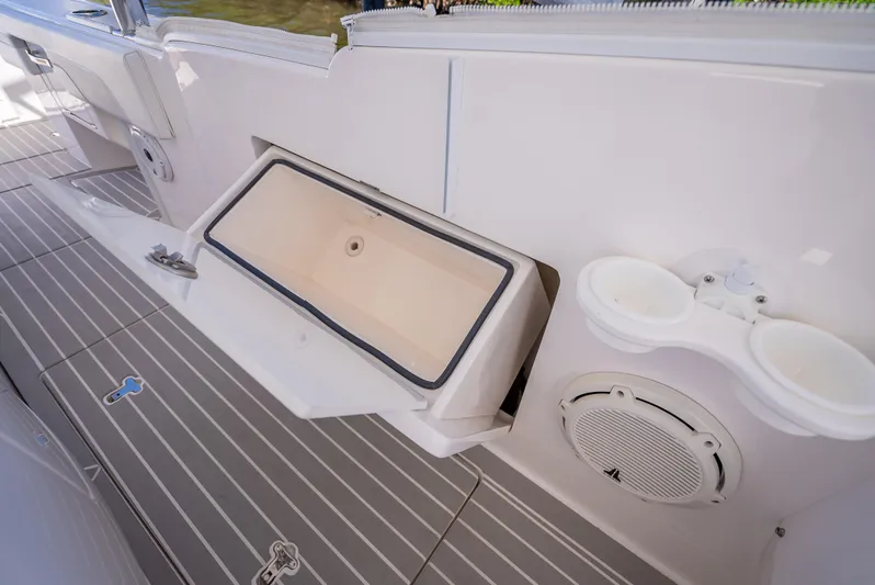  Yacht Photos Pics 2020 Intrepid 407 Cuddy boat interior with storage compartment and speaker.