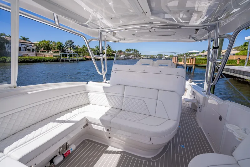  Yacht Photos Pics 2020 Intrepid 407 Cuddy boat interior with white seating, dockside view.