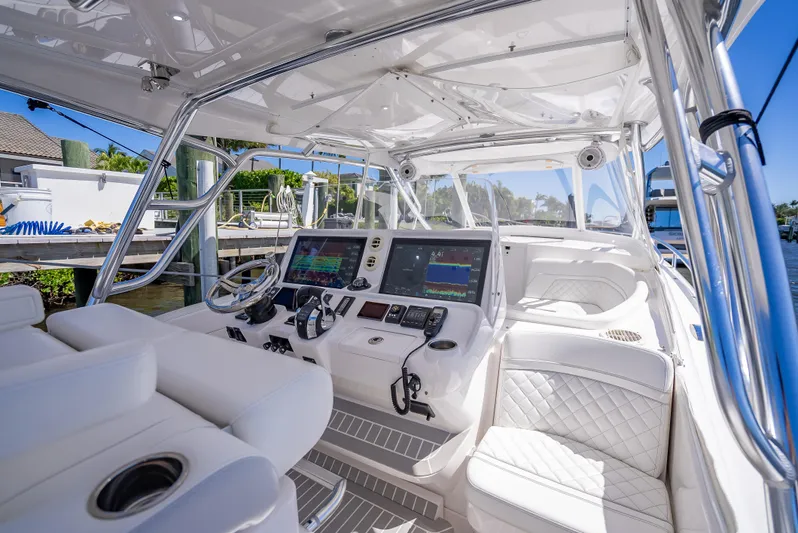  Yacht Photos Pics Luxurious 2020 Intrepid 407 Cuddy boat interior with advanced navigation systems and plush seating.