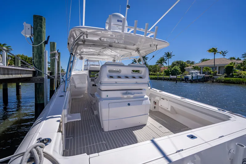  Yacht Photos Pics 2020 Intrepid 407 Cuddy boat docked by a scenic waterfront.