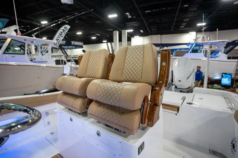  Yacht Photos Pics 2025 Caymas 291 HB boat with luxurious tan quilted seats at a boat show.