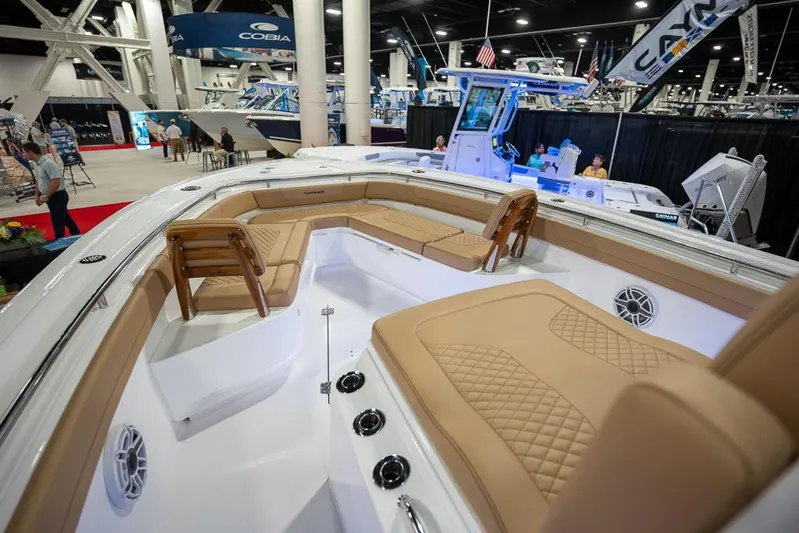 Yacht Photos Pics 2025 Caymas 291 HB boat interior with tan seating at a boat show.