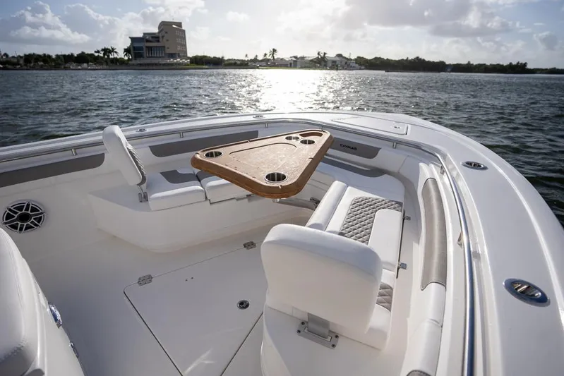  Yacht Photos Pics 2025 Caymas 291 HB boat interior with seating and table on calm water.