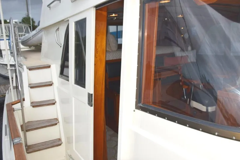 Qa3 Yacht Photos Pics Pilothouse Door and steps up to flybridge. Teak bow rail cap.